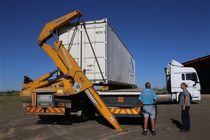 Kraan zet container op trailer